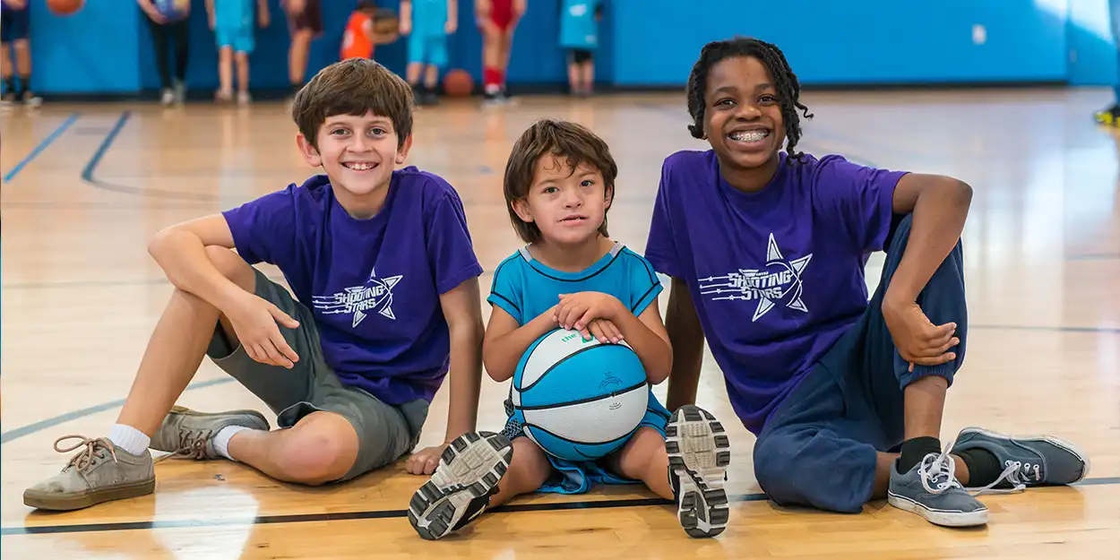 image of participant playing basketball with buddies